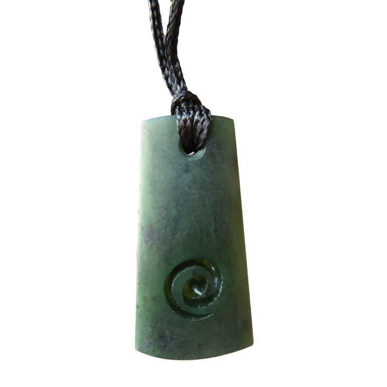 Greenstone wedge-shaped toki or pendant with koru carving