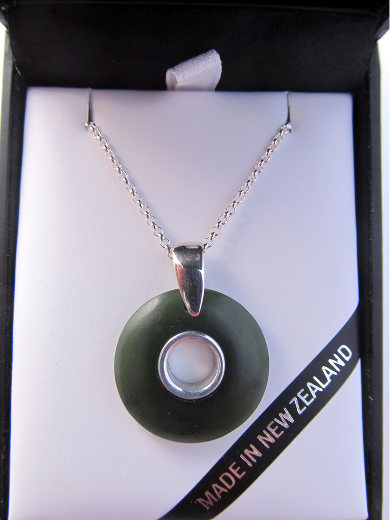 1022 Round doughnut shaped greenstone pendant (2.1cm) with silver inlay.
